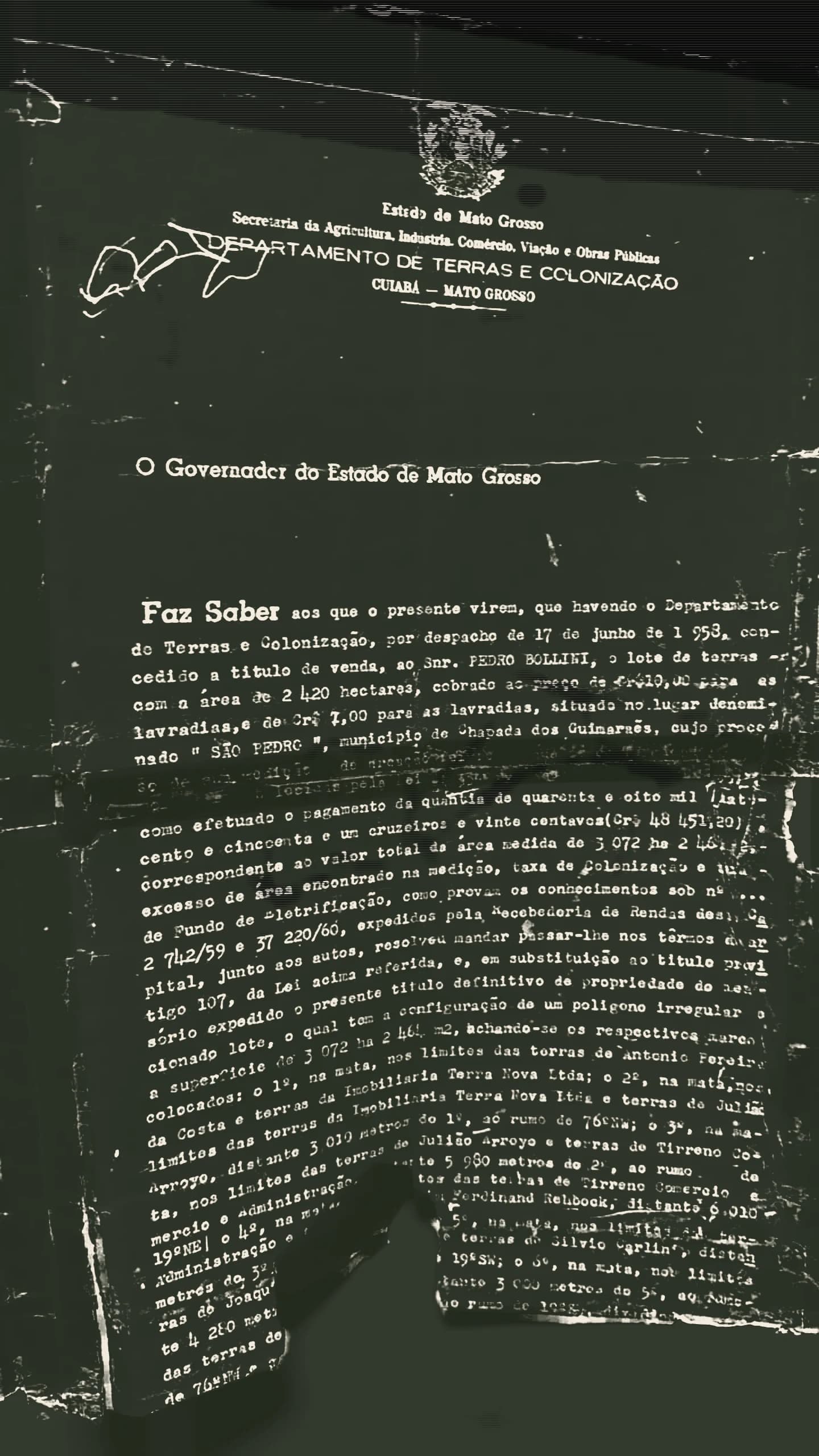 The title of ownership issued by the Governor of Mato Grosso through the Department of Lands and Colonization, typed on the state letterhead, granting Pedro Bollini the lot São Pedro in the municipality of Chapada dos Guimarães. The paper is creased, taped at the edges and torn at the foot.